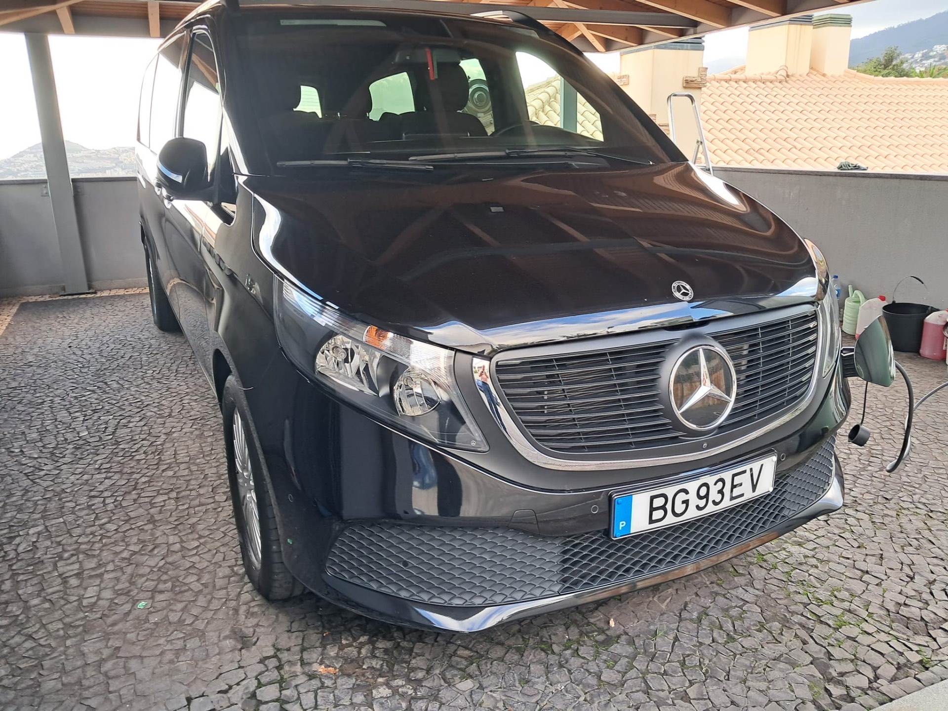 Black Mercedes-Benz EQV electric van charging, front view — MG Madeira Tours VIP fleet